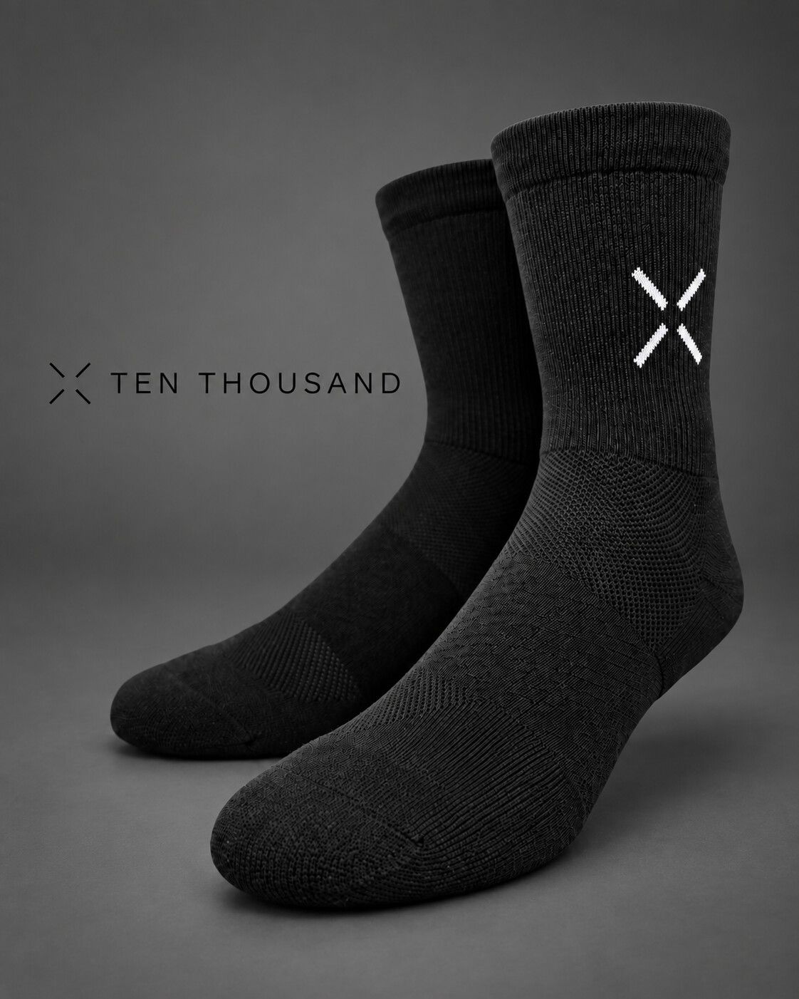 Black Ten Thousand performance socks on a dark grey background