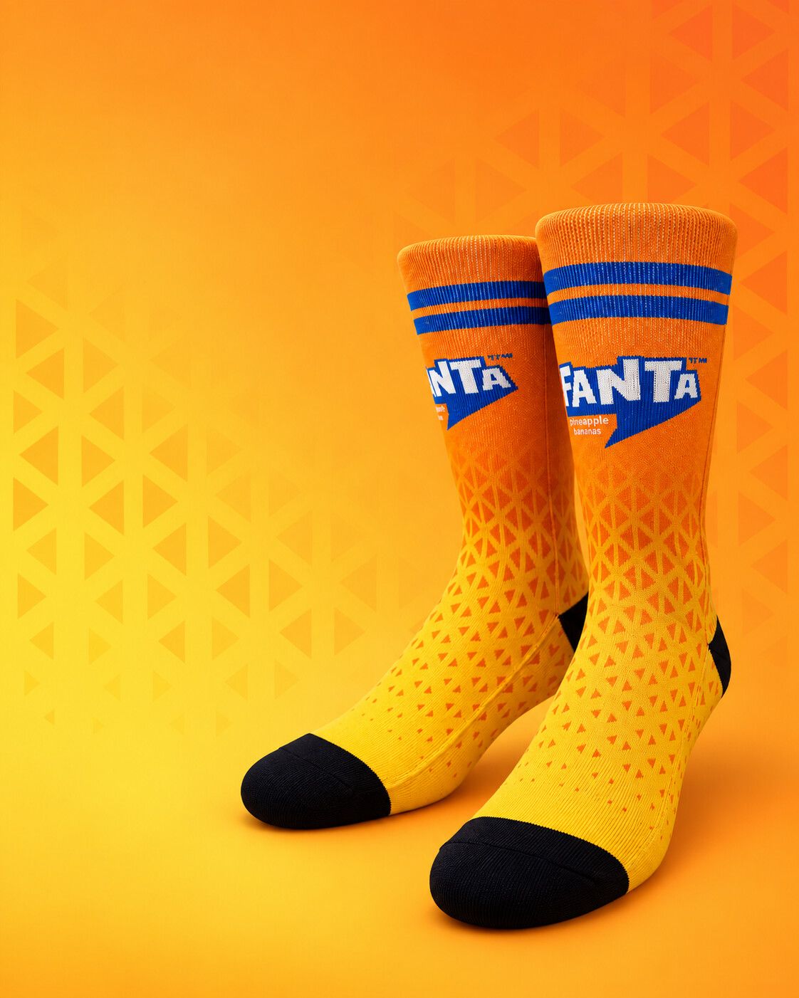 Orange and yellow Fanta sublimation socks on an orange background